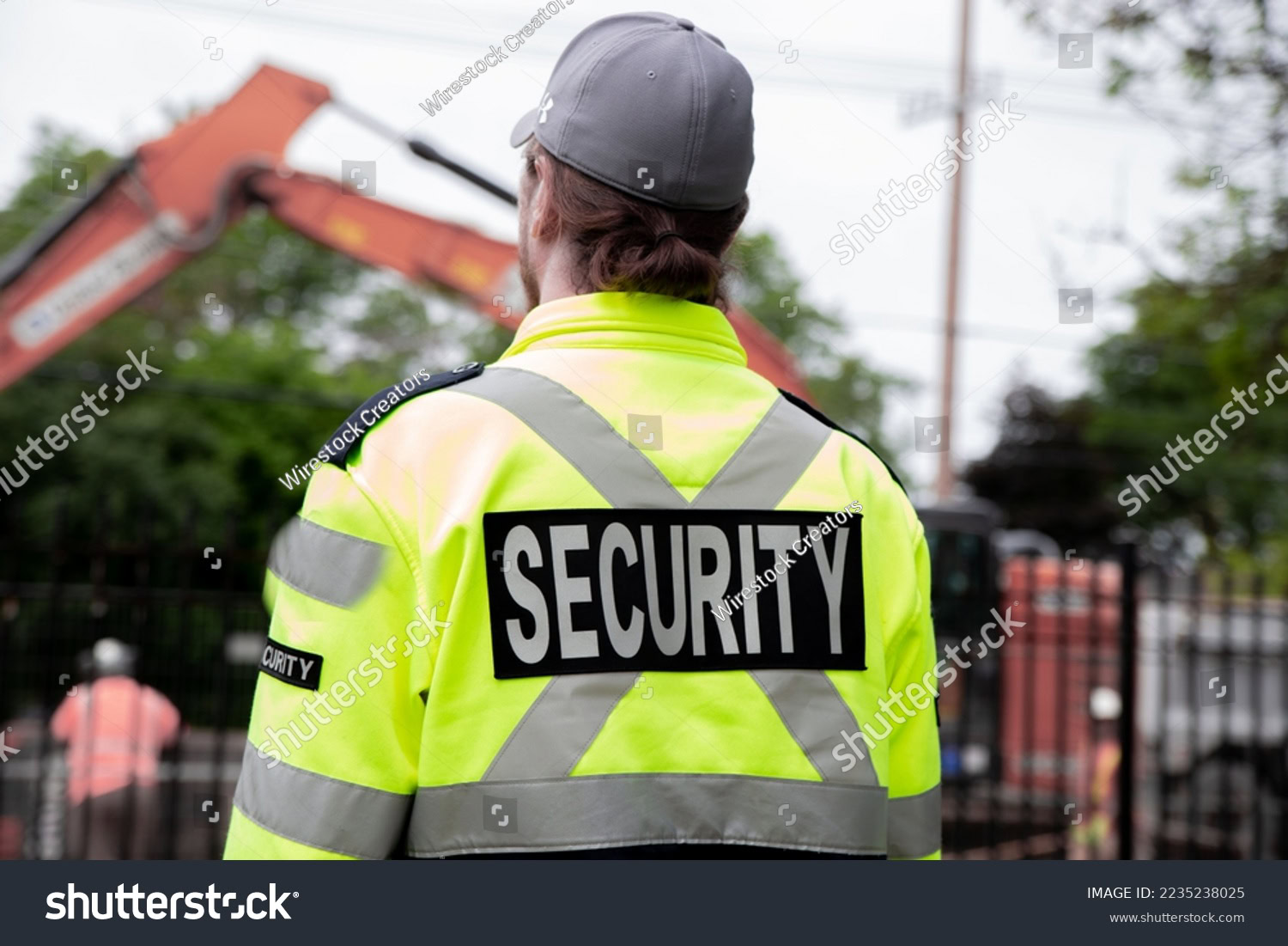 Stock Photo A Security Guard Patrolling The Street Next To The Construction Area 2235238025 Copy